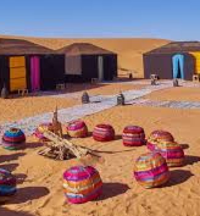 Breathtaking view of the Merzouga Sahara desert at sunrise, showcasing the vast golden sand dunes stretching into the horizon. The serene beauty of this iconic Moroccan landscape is captured in the heart of the Sahara, offering a glimpse into the untouched wilderness and the tranquil beauty of the desert. A perfect image of adventure and nature’s splendor in the Merzouga Sahara, ideal for travel enthusiasts and desert explorers