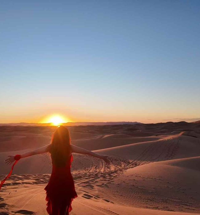 Breathtaking view of the Merzouga Sahara desert at sunrise, showcasing the vast golden sand dunes stretching into the horizon. The serene beauty of this iconic Moroccan landscape is captured in the heart of the Sahara, offering a glimpse into the untouched wilderness and the tranquil beauty of the desert. A perfect image of adventure and nature’s splendor in the Merzouga Sahara, ideal for travel enthusiasts and desert explorers